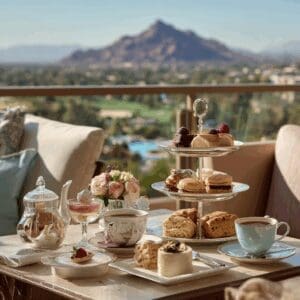 Outdoor terrace tea service at The Phoenician with fine china, pastries, and Camelback Mountain views in Scottsdale, Arizona.