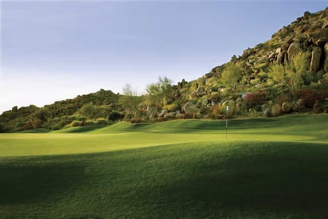Blooming beauty meets bold strategy: This floral-framed green at a top Scottsdale course invites all skill levels to conquer the desert's subtle challenges.